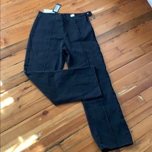 Never worn, black wide-legged jeans.